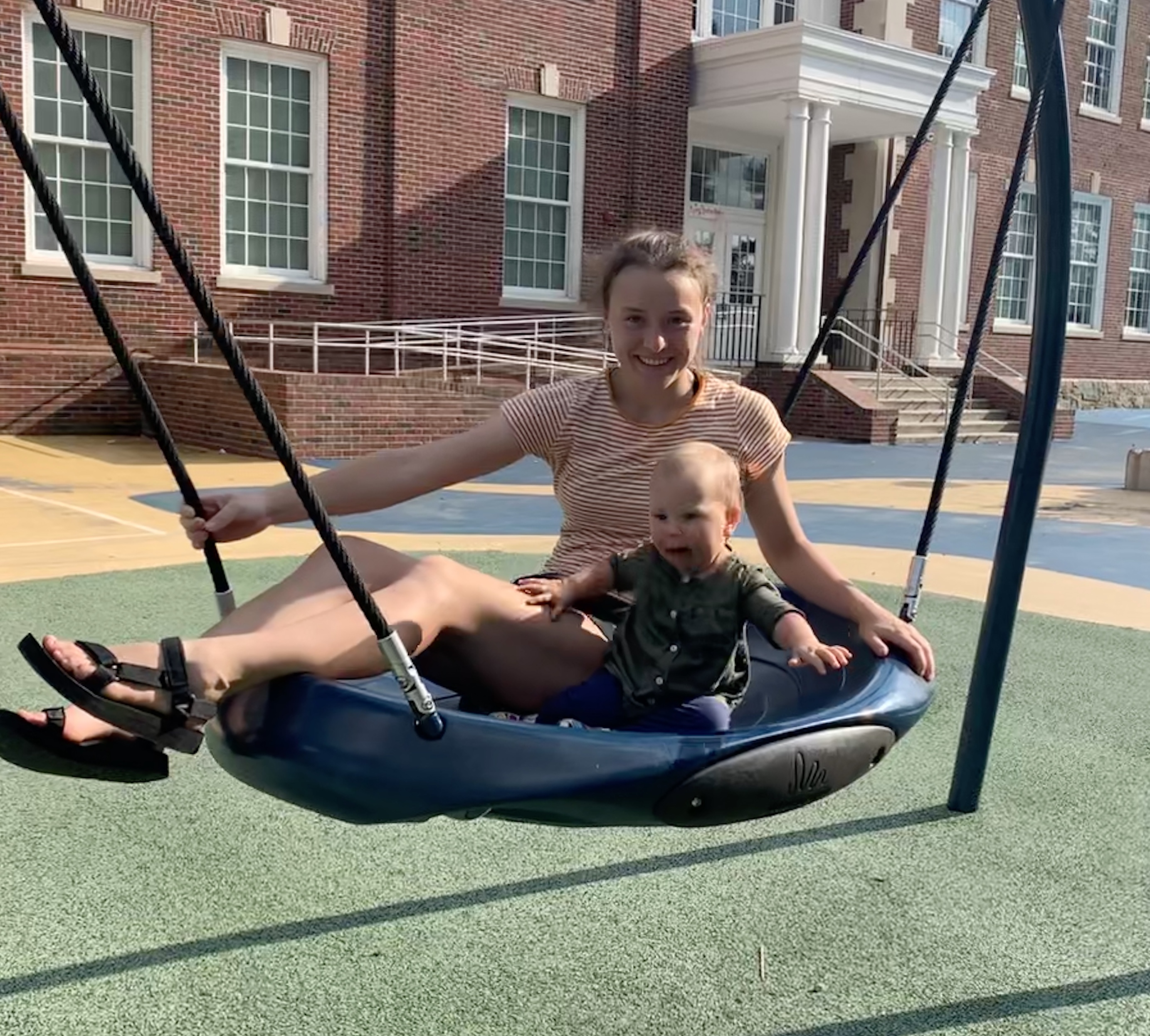 Michelle and Leah both on a circle swing at Lafayette Park in D.C. in August 2020